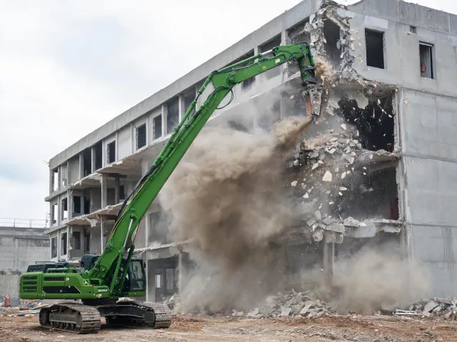 Building demolition with high-reach excavator
